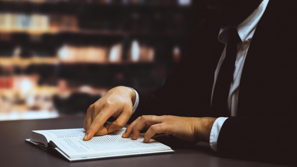 black-suitclad-businessman-lawyer-studying-book-library-equilibrium