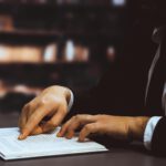 black-suitclad-businessman-lawyer-studying-book-library-equilibrium