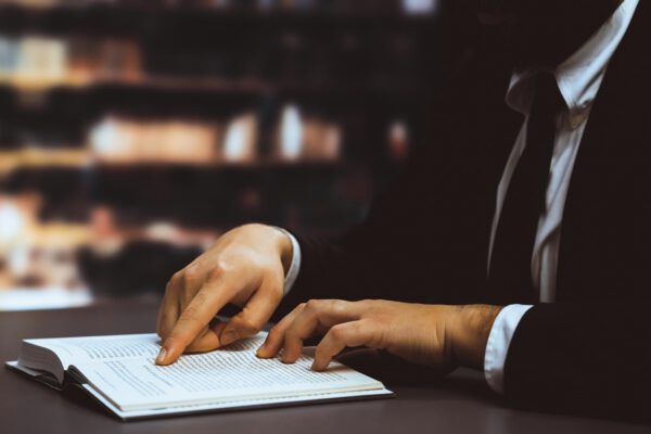 black-suitclad-businessman-lawyer-studying-book-library-equilibrium
